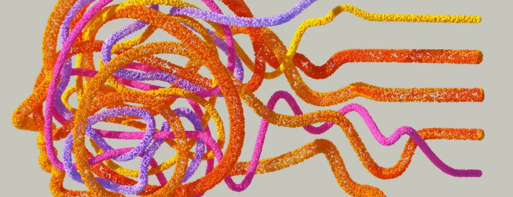 Colourful, textured strands in pink, orange, yellow, and purple intertwine and twist against a light grey background, creating an abstract, dynamic pattern.