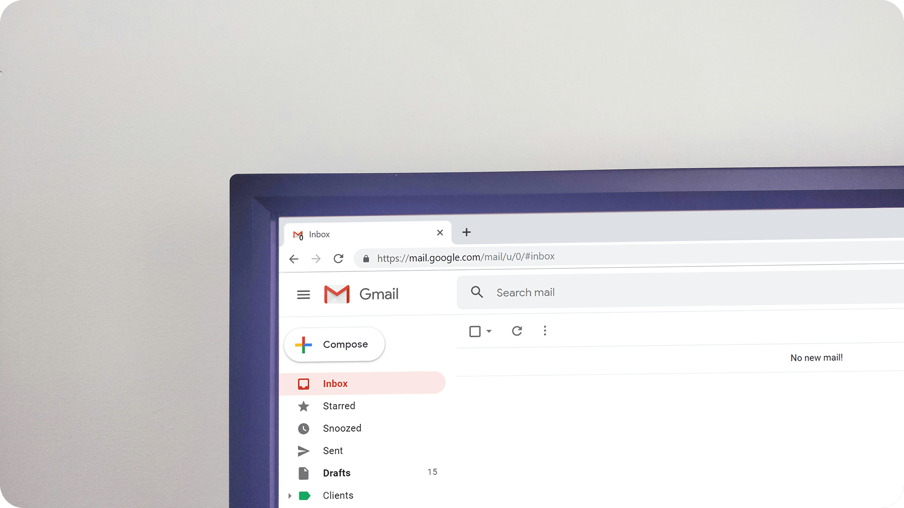 A computer screen displays an open Gmail inbox with no new mail. The browser address bar shows the Gmail URL, and the left sidebar lists mail folders such as Inbox, Starred, and Sent.
